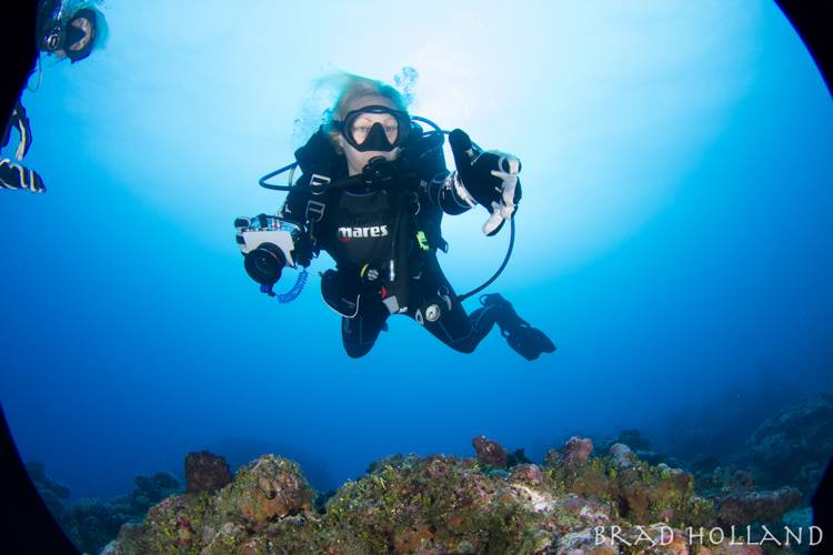 Stephanie in Yap pointing over reef.